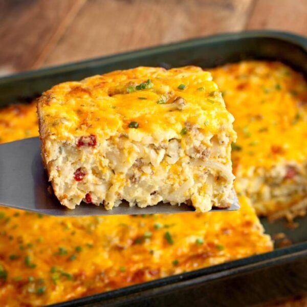 Sausage hashbrown breakfast casserole with a serving on a spatula
